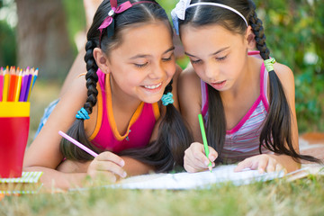 Wall Mural - Sisters reading book in summer park