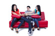 © Creativa Images - Three young teenagers fighting for remote control