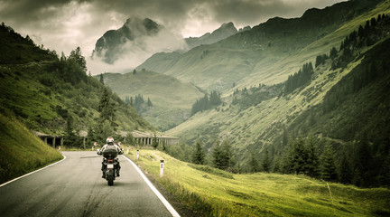 Wall Mural - motorcyclist on mountainous highway