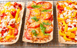 Backed flatbread with variety of toppings.