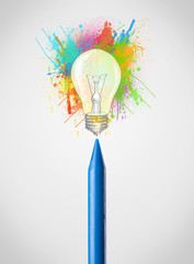 Crayon close-up with colored paint splashes and lightbulb