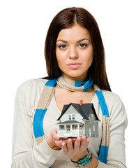 Woman wearing colored scarf hands small model house