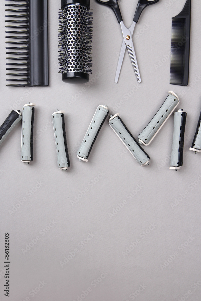 Professional hairdresser tools on gray background