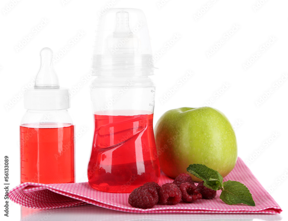 Fruits and baby bottles with compote on napkin isolated on