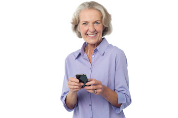 Aged woman texting on her mobile phone