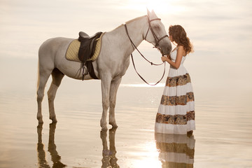 Young woman on a horse. Horseback rider, woman riding horse on b