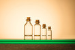 Four size of glass bottles isolated on yellow background