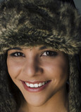 Fototapeta  - Happy smiling beautiful woman in fur hat