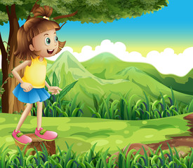 Wall Mural - A happy girl standing above a stump at the hill