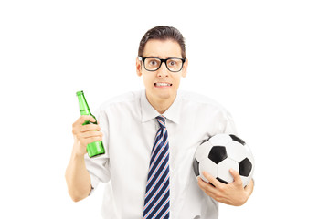 Canvas Print - Scared male in shirt holding a beer bottle and football