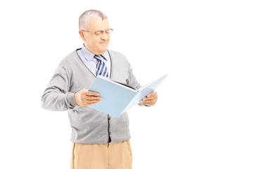 Poster - Smiling middle aged gentleman reading a book