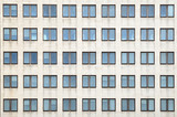 Fototapeta Na drzwi - Multiple closed windows on a large office building