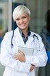 © Francesco83 - Smiling attractive female doctor with stethoscope in front of a
