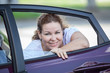 © Kekyalyaynen - Young joyous beauty woman looking at opened car window in door