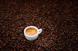 Coffee beans with white cup espresso. Background concept