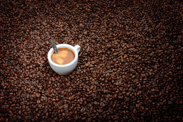 Coffee beans with white cup espresso. Background concept