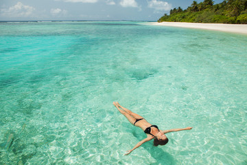 Wall Mural - Woman relaxing  in the sea