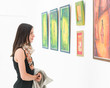 © Daco - woman admiring colorful painting