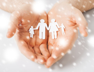 man hands showing family of paper people