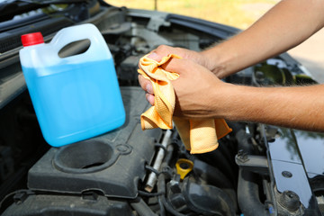 Motor mechanic cleaning his greasy hands after servicing car