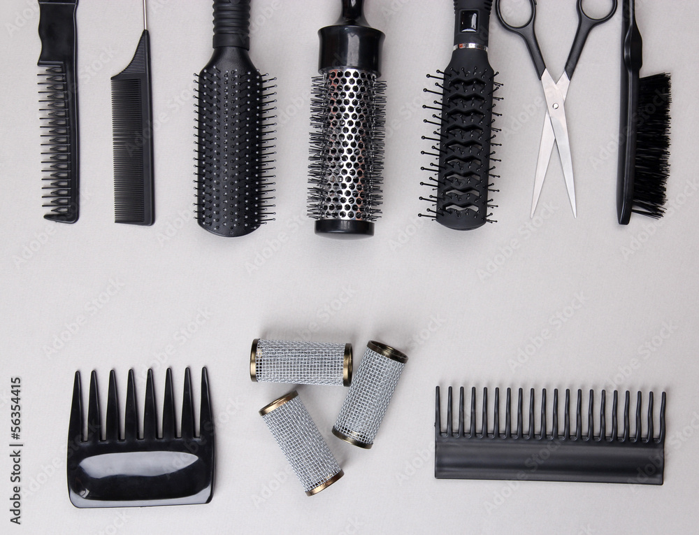 Professional hairdresser tools on gray background