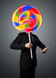 © ra2 studio - Businessman holding a lollipop