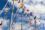 Fototapeta  - Colourful signal flags on a sailing boat