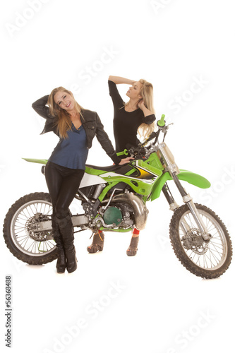 Fotografia, Obraz  Two women posing by a dirt bike