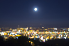 Full Moon Rise Over Blurred City Lights Landscape