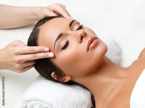 Fotografie, Obraz Face Massage. Close-up of a Young Woman Getting Spa Treatment.