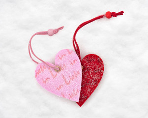 two heart toys covered with snow