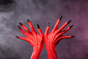 Sticker - red devil hands with sharp black nails, extreme body-art