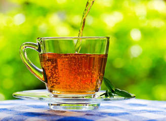 Sticker - Cup of tea on nature background