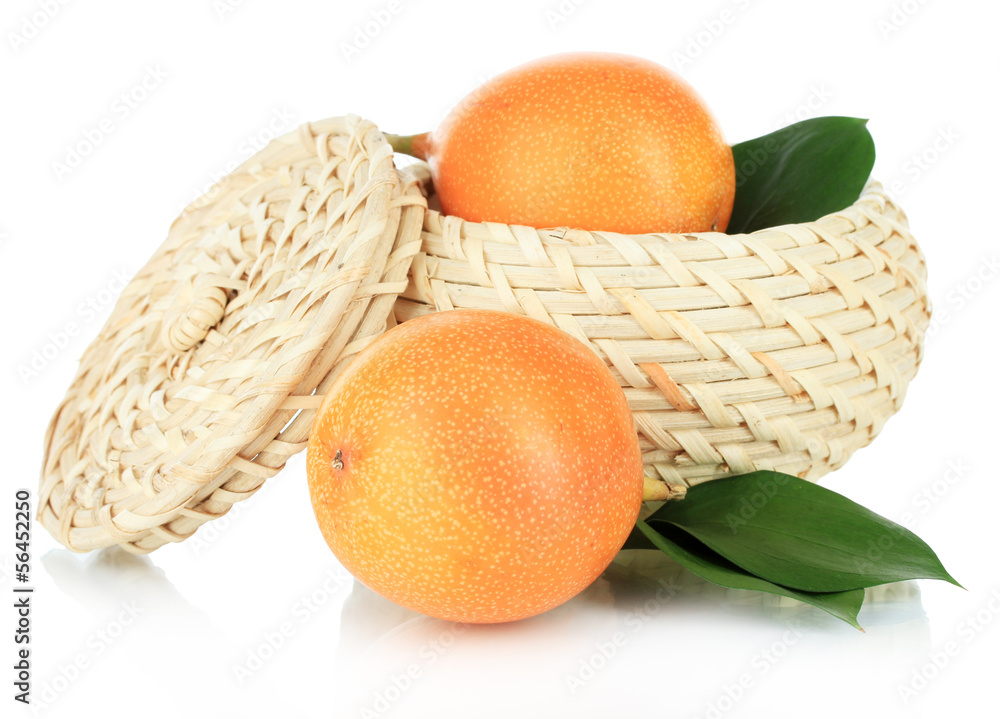 Passion fruits in wicker basket isolated on white