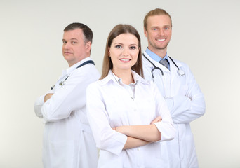 Canvas Print - Medical workers on grey background