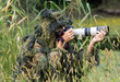 Photographer in ghillie suit in action