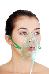 diseased female patient wearing a oxygen mask