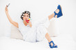 © lightwavemedia - Brunette in hair rollers and wedge shoes drinking a cocktail tak