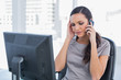 © WavebreakMediaMicro - Dark haired businesswoman with headache having a phone conversat