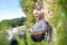 Man Relaxing In Country House On Week-end