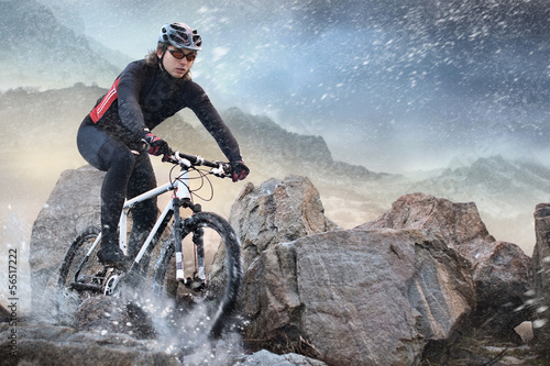 Foto-Stoff bedruckt - Cyclist climbing on a rock (von vitaliy_melnik)