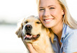 © Karramba Production - Close up of blond woman embracing golden retriever