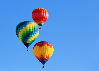 hot air balloons against blue sky