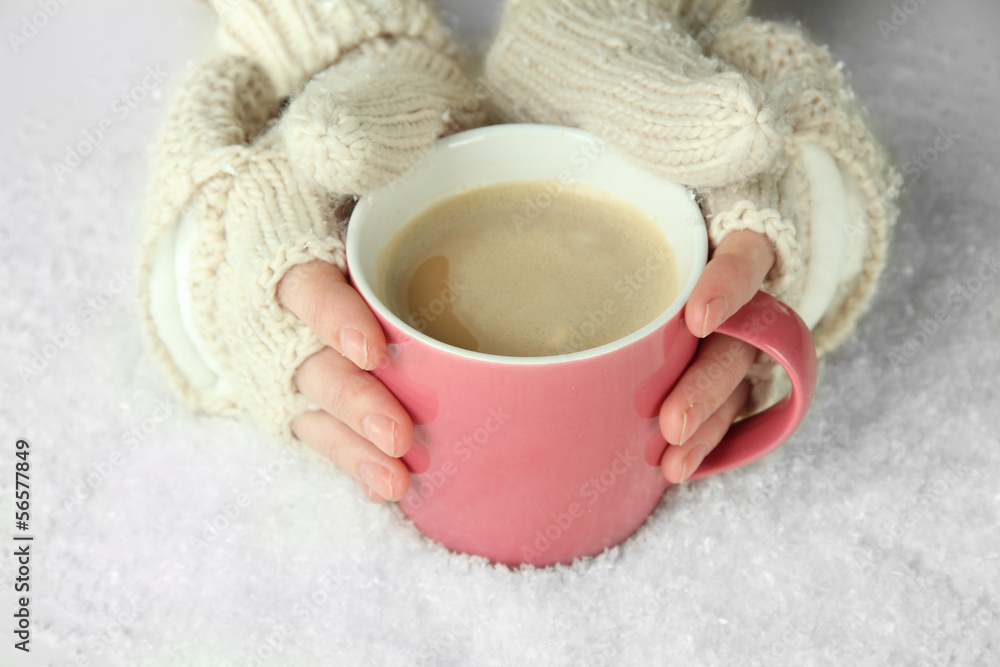 Female hands with hit drink, on light background