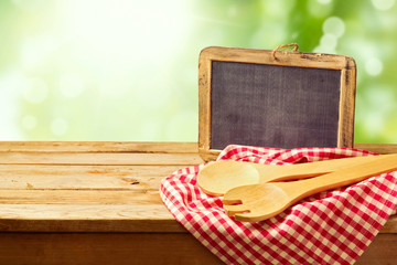 Wall Mural - Cooking and backing background with wooden table and chalkboard