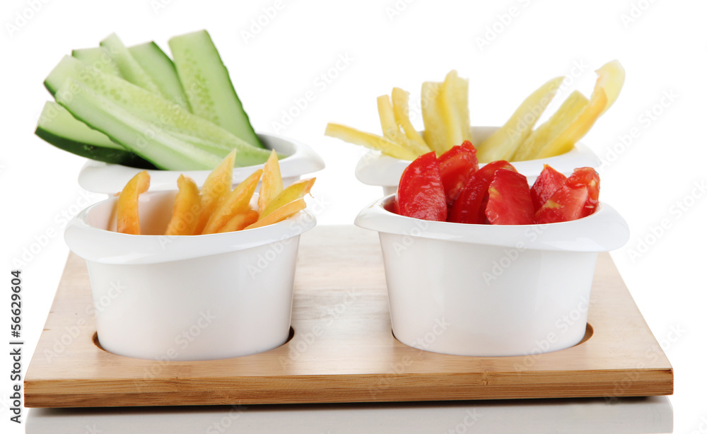 Bright fresh vegetables cut up slices in bowls isolated on