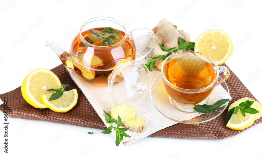 Kettle and cup of tea with ginger on napkin isolated on white