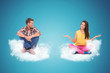 © Viorel Sima - two young people sitting on clouds welcoming