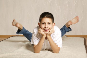 little funny boy lying on floor