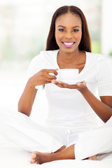 Wall Mural - african woman enjoying a cup of coffee